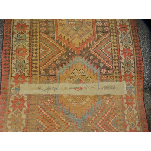 75 - A North African design rug, decorated with repeating star and other designs, on a multi-coloured gro... 