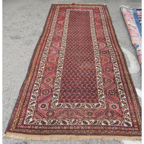 78 - A Persian runner, decorated with a central panel, bordered by zig-zag and foliate designs, on a main... 