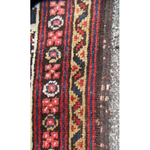 78 - A Persian runner, decorated with a central panel, bordered by zig-zag and foliate designs, on a main... 