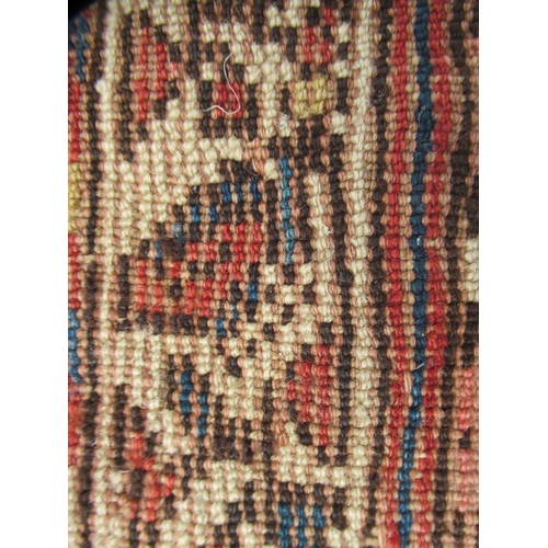 78 - A Persian runner, decorated with a central panel, bordered by zig-zag and foliate designs, on a main... 