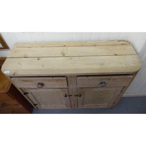 79 - A late 19thC bleached pine side cabinet with two drawers, over two panelled doors, on a plinth&nbsp;... 