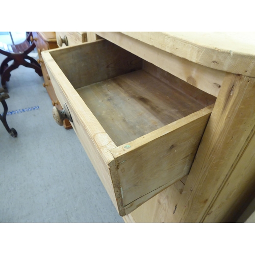 79 - A late 19thC bleached pine side cabinet with two drawers, over two panelled doors, on a plinth&nbsp;... 