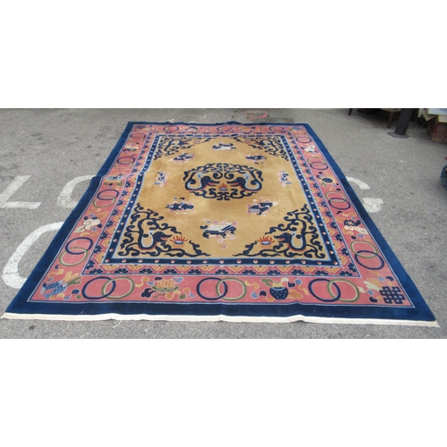83 - A Chinese carpet, decorated in bright pastel tones within a dark blue border, a dragon and other des... 