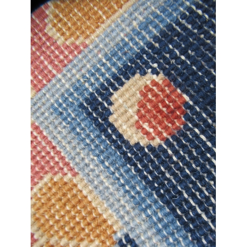 83 - A Chinese carpet, decorated in bright pastel tones within a dark blue border, a dragon and other des... 