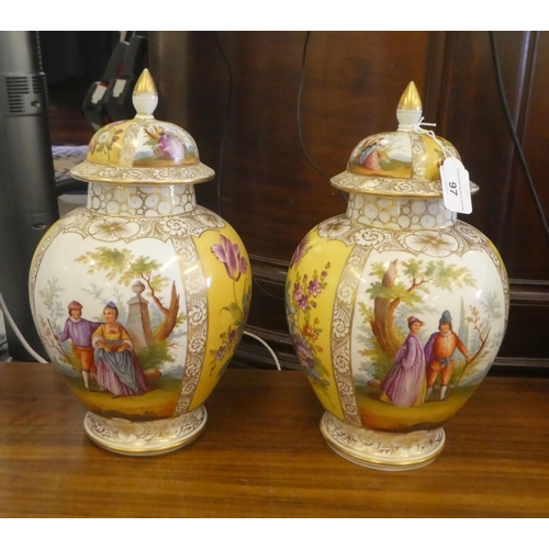 97 - A pair of Dresden porcelain vases and covers, each decorated with panels, depicting a courting coupl... 
