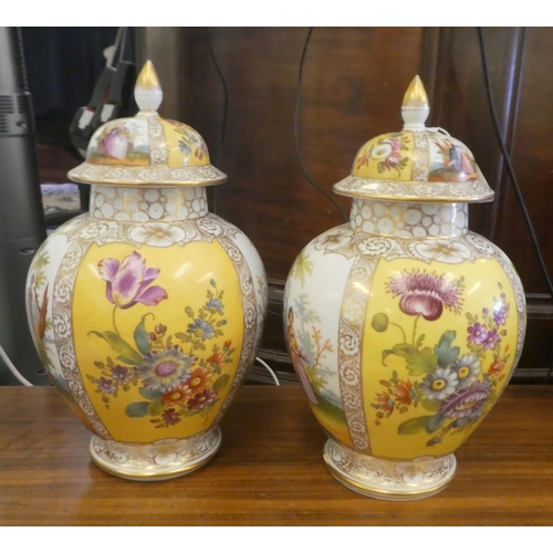 97 - A pair of Dresden porcelain vases and covers, each decorated with panels, depicting a courting coupl... 
