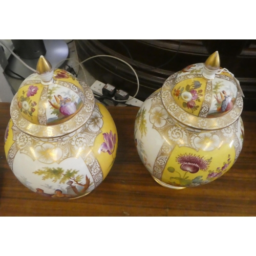 97 - A pair of Dresden porcelain vases and covers, each decorated with panels, depicting a courting coupl... 