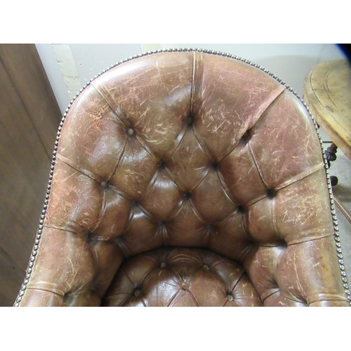 98 - An early 19thC style tub design study chair with a studded and buttoned, mid brown hide back and sea... 