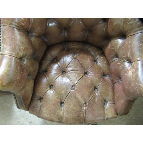 98 - An early 19thC style tub design study chair with a studded and buttoned, mid brown hide back and sea... 