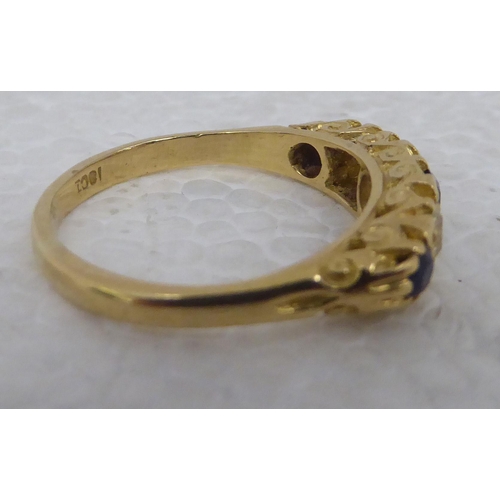 99 - A gold coloured metal ring&nbsp; stamped 18ct, set with alternating sapphires and diamonds&nbsp;