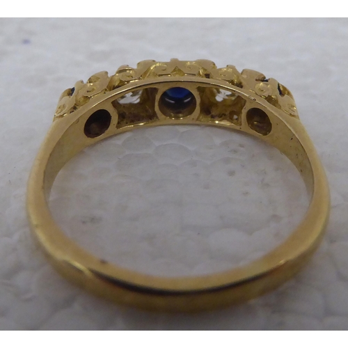 99 - A gold coloured metal ring&nbsp; stamped 18ct, set with alternating sapphires and diamonds&nbsp;