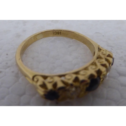 99 - A gold coloured metal ring&nbsp; stamped 18ct, set with alternating sapphires and diamonds&nbsp;