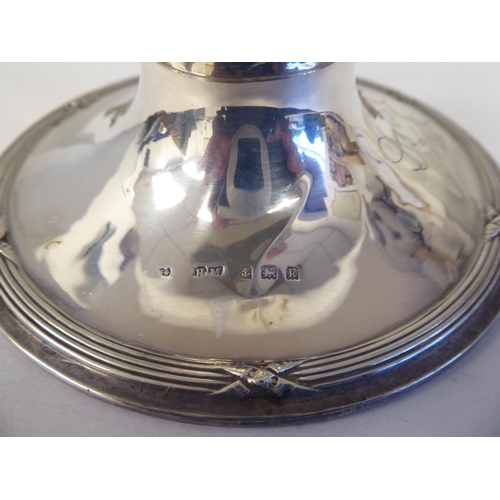 1 - An Edwardian loaded silver capstan design inkwell with cast ribbon tied ornament and a piquetworked ... 