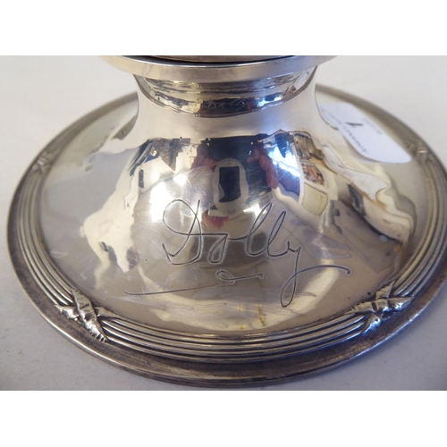 1 - An Edwardian loaded silver capstan design inkwell with cast ribbon tied ornament and a piquetworked ... 