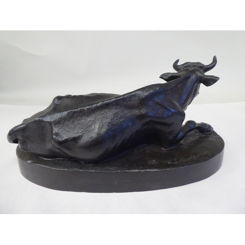 10 - A cast and patinated bronze model, a recumbent cow, on an oval base  bears an indistinctly impr... 