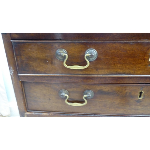 104 - A George III mahogany bachelor's chest, the top with re-entrant corners, over a brushing slide and f... 