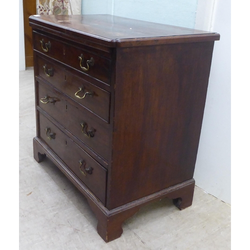 104 - A George III mahogany bachelor's chest, the top with re-entrant corners, over a brushing slide and f... 