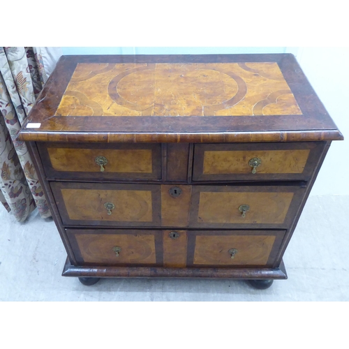 108 - An 18thC figured and inlaid walnut dressing chest, the top with a cushion moulded border, over two s... 