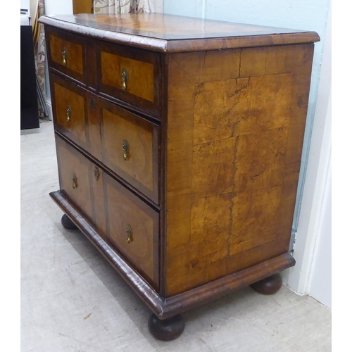 108 - An 18thC figured and inlaid walnut dressing chest, the top with a cushion moulded border, over two s... 