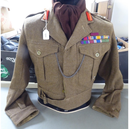 111 - Two vintage British Army battledress tunics, one with emblems and an associated beret(Please Note: t... 