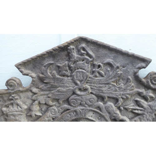 113 - An antique black painted, cast iron fireback, incorporating a Royal coat of arms, the initials ER an... 