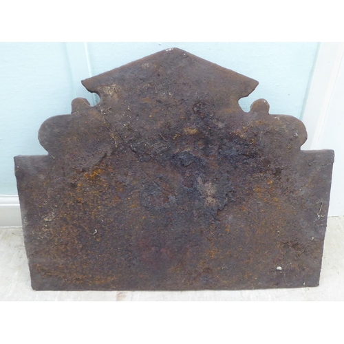 113 - An antique black painted, cast iron fireback, incorporating a Royal coat of arms, the initials ER an... 