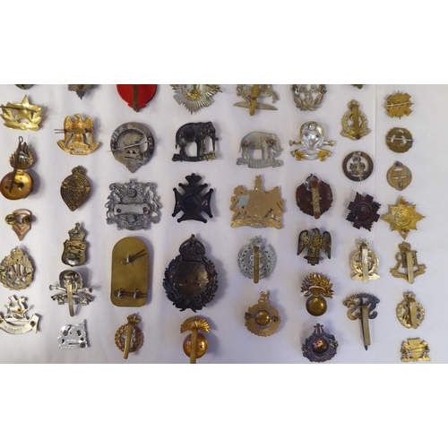 130 - Approx. fifty-five military cap badges and other insignia, some copies: to include 19th PWO Hussars;... 