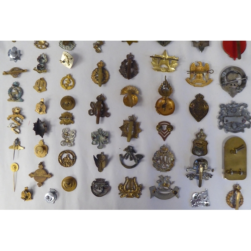 130 - Approx. fifty-five military cap badges and other insignia, some copies: to include 19th PWO Hussars;... 