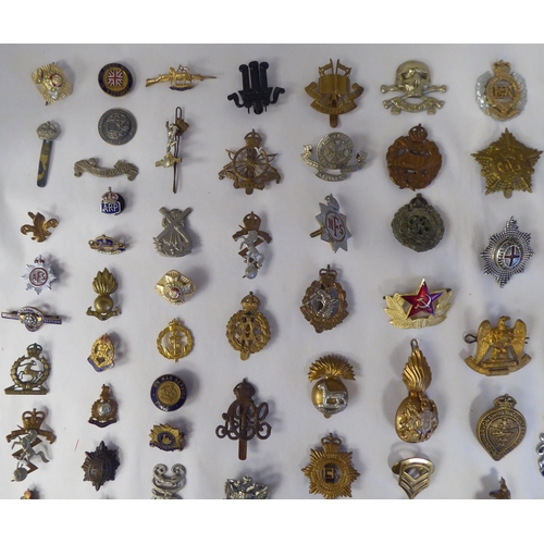 130 - Approx. fifty-five military cap badges and other insignia, some copies: to include 19th PWO Hussars;... 