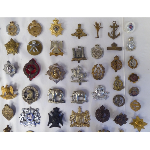 130 - Approx. fifty-five military cap badges and other insignia, some copies: to include 19th PWO Hussars;... 