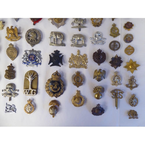 130 - Approx. fifty-five military cap badges and other insignia, some copies: to include 19th PWO Hussars;... 