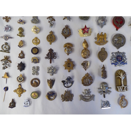 130 - Approx. fifty-five military cap badges and other insignia, some copies: to include 19th PWO Hussars;... 