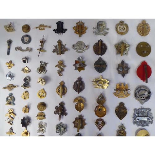 130 - Approx. fifty-five military cap badges and other insignia, some copies: to include 19th PWO Hussars;... 