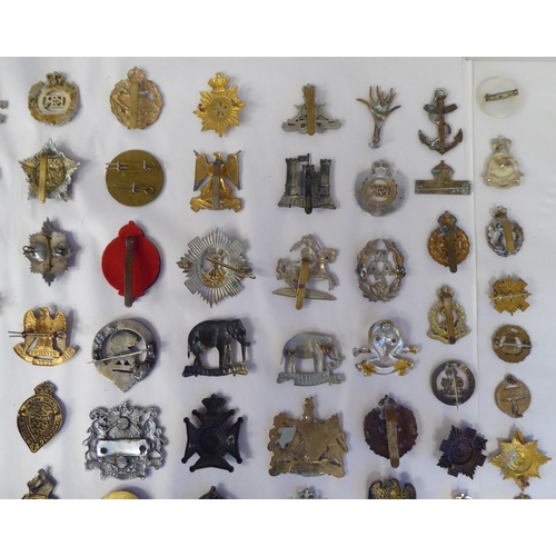 130 - Approx. fifty-five military cap badges and other insignia, some copies: to include 19th PWO Hussars;... 