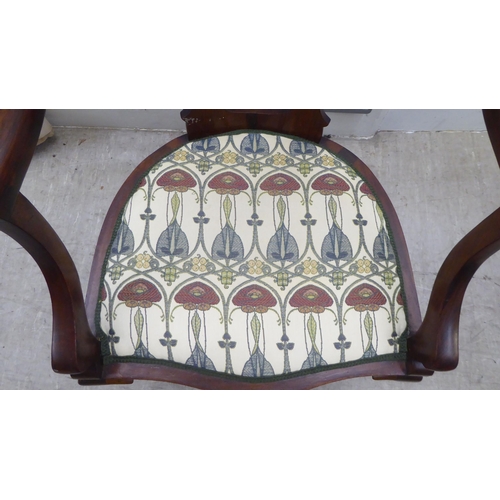 133 - An Art Nouveau style Jones & Higgins mahogany framed chair with an open foliate scroll carved an... 