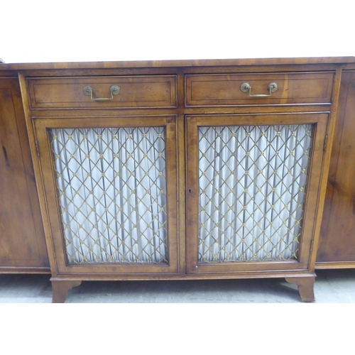 134 - A modern Regency style yewwood finished, breakfront sideboard with ebony string inlaid decoration, c... 