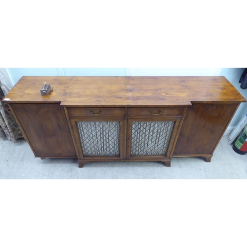 134 - A modern Regency style yewwood finished, breakfront sideboard with ebony string inlaid decoration, c... 