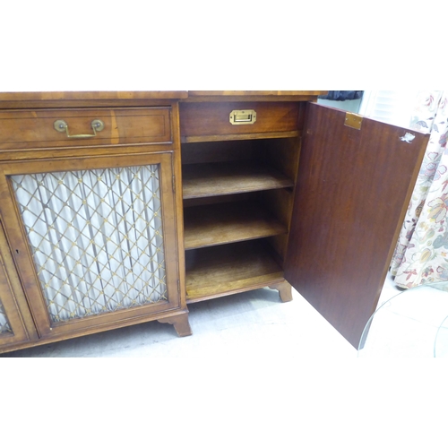 134 - A modern Regency style yewwood finished, breakfront sideboard with ebony string inlaid decoration, c... 