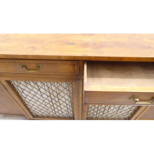 134 - A modern Regency style yewwood finished, breakfront sideboard with ebony string inlaid decoration, c... 