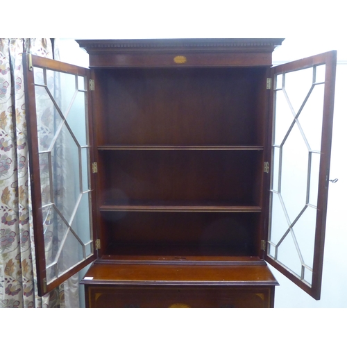 135 - An Edwardian style satinwood, string inlaid, crossbanded mahogany cabinet bookcase, the upper part e... 