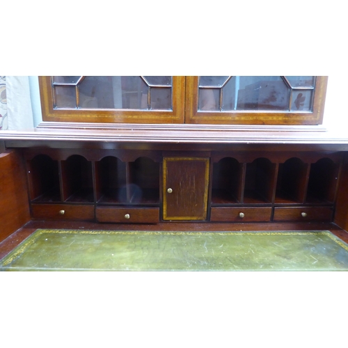 135 - An Edwardian style satinwood, string inlaid, crossbanded mahogany cabinet bookcase, the upper part e... 