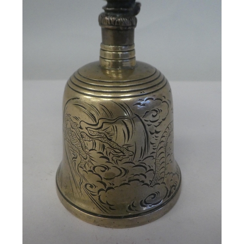 136 - 19th/20thC Chinese metalware, viz. a bronze table bell, engraved with dragons and surmounted by a my... 