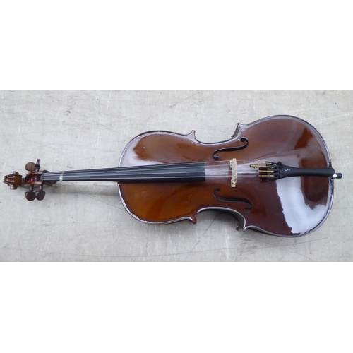 137 - A modern quarter size and a half size cello with fabric carrying cases; and another (empty) fitted c... 