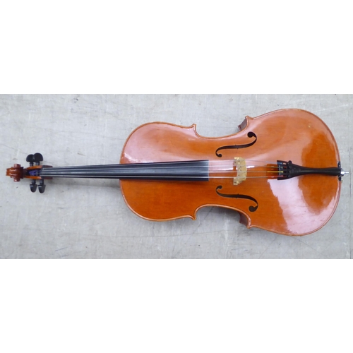 137 - A modern quarter size and a half size cello with fabric carrying cases; and another (empty) fitted c... 