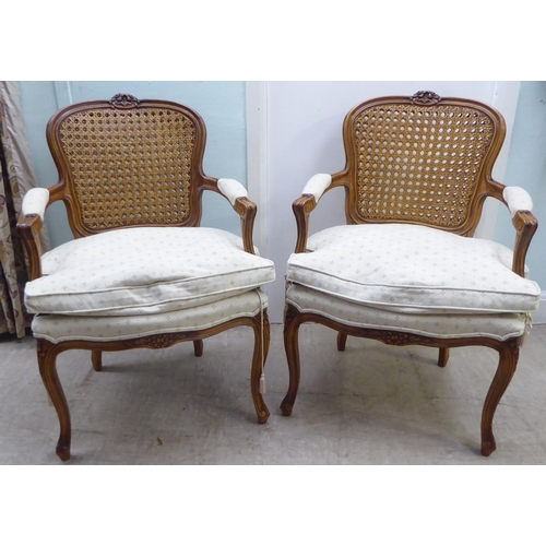 146 - A pair of modern French style, moulded and carved beech framed open arm chairs, each having a double... 