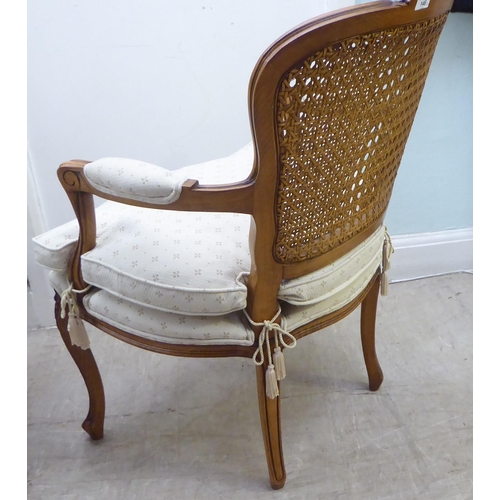 146 - A pair of modern French style, moulded and carved beech framed open arm chairs, each having a double... 