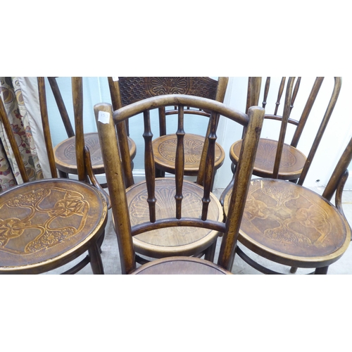 153 - A set of three early 20thC Mundis bentwood chairs with solid, stencilled seats; and two similar pair... 