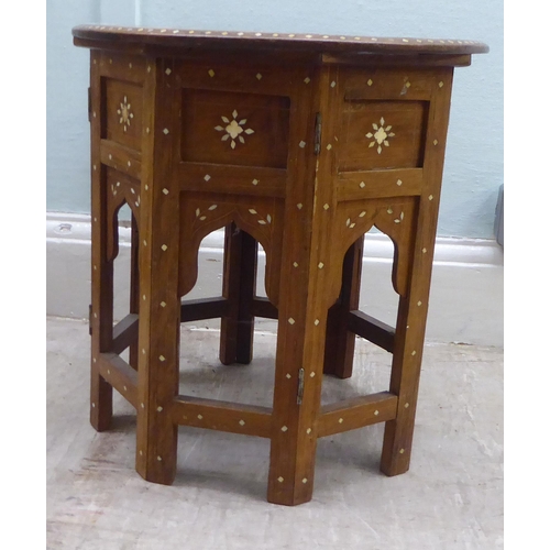 156 - An early 20thC North African hardwood side table, intricately inlaid in bone and mother-of-pearl wit... 