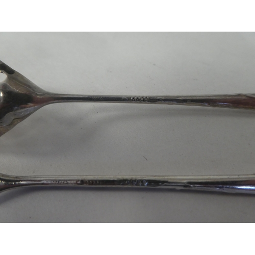 160 - A Liberty & Co silver coloured metal olive spoon and fork, on decoratively cast handles 