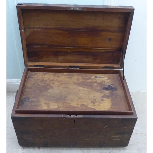 161 - A late 19thC hardwood trunk with iron brackets and flank bail handles with an inscribed brass namepl... 